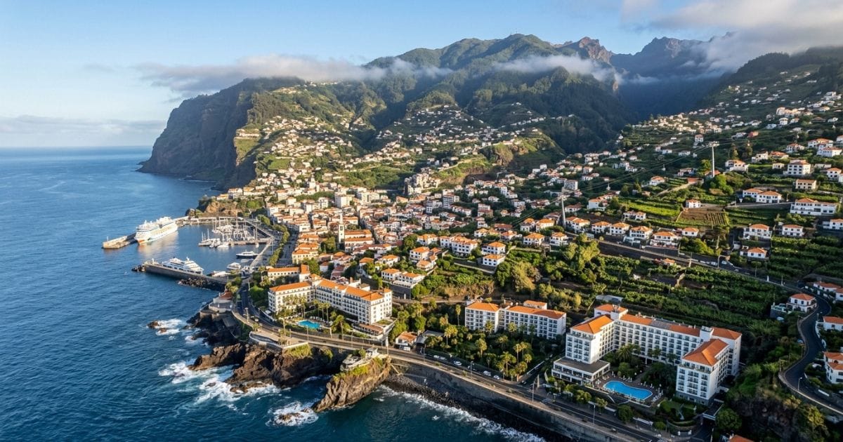 Ariel view of Funchal, Madeira, Portugal showing the rugged coatlind and steep banking hills leading inland.