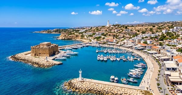 Paphos medieval castle, promenade and fishing boats in the harbour.